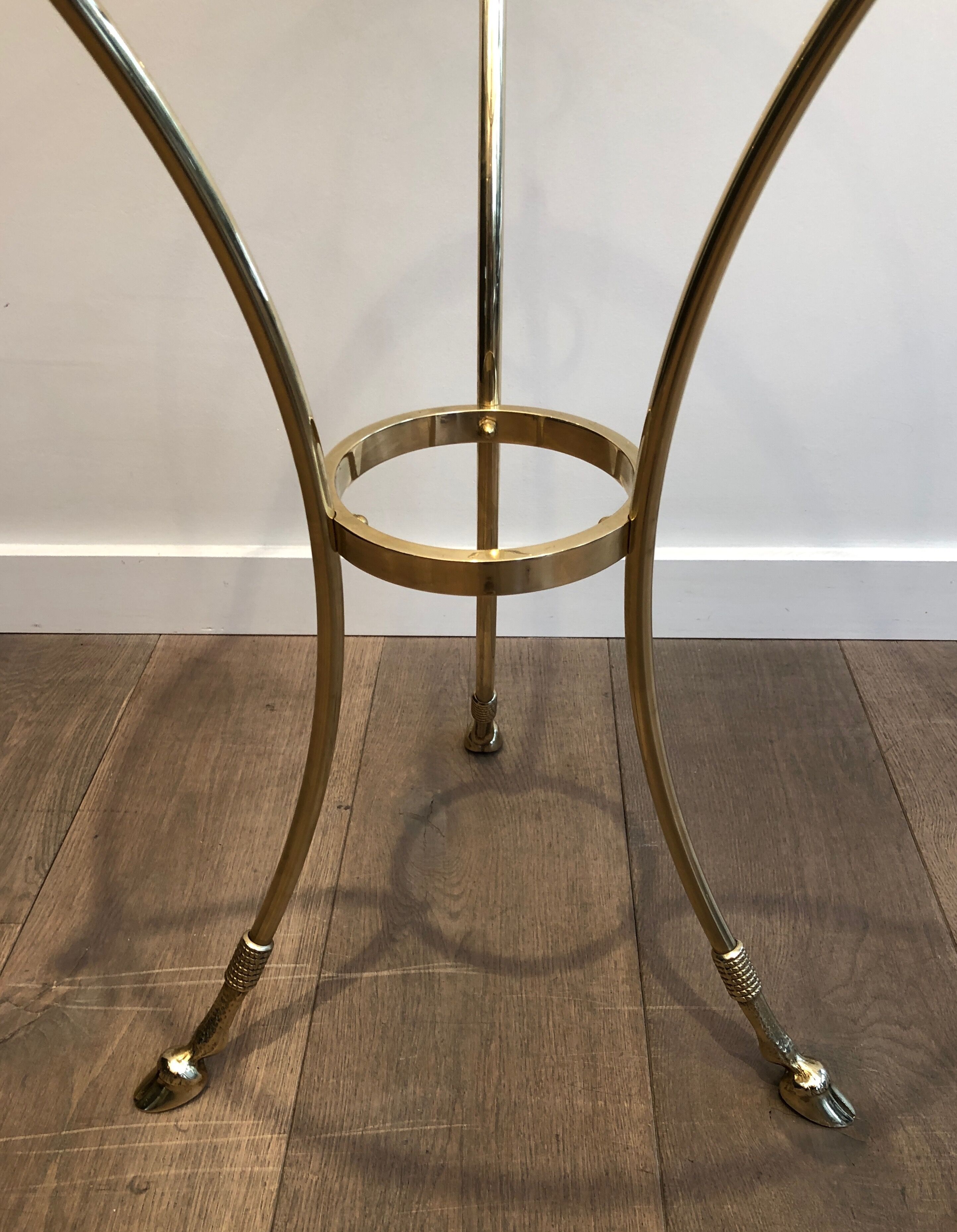 Neoclassical style tripod pedestal table in brass and round glass top in the taste of the House