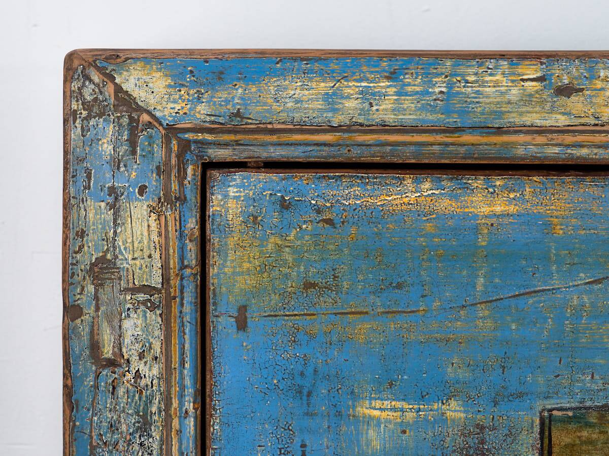 Old wooden entrance buffet in blue and yellow tones (circa 1920).