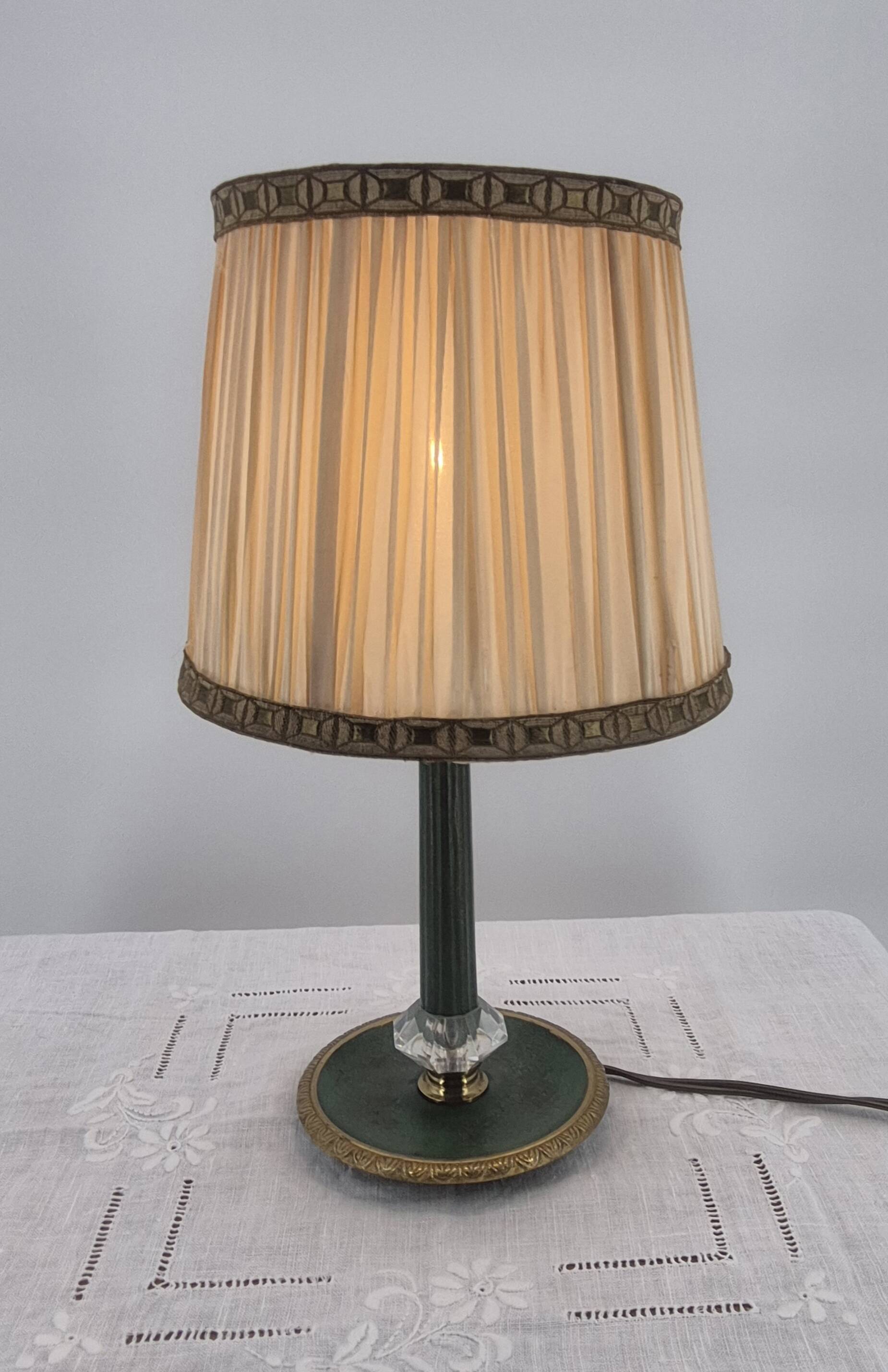 Brass table lamp with green patina and empire-style fabric shade.