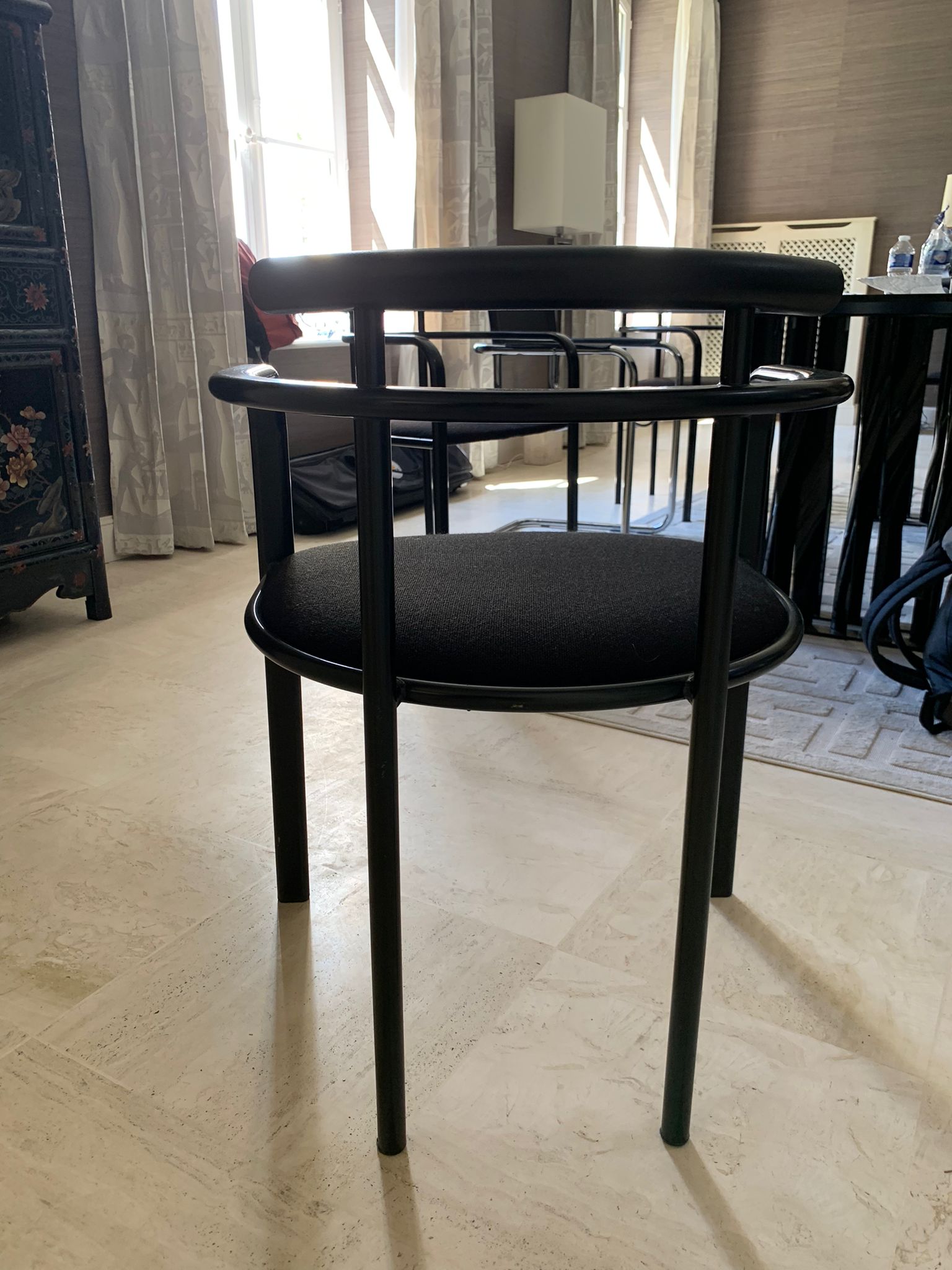 Black dining room table, wooden, rectangle with upholstered chairs.