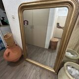 Antique gilded mirror in old Louis Philippe wood