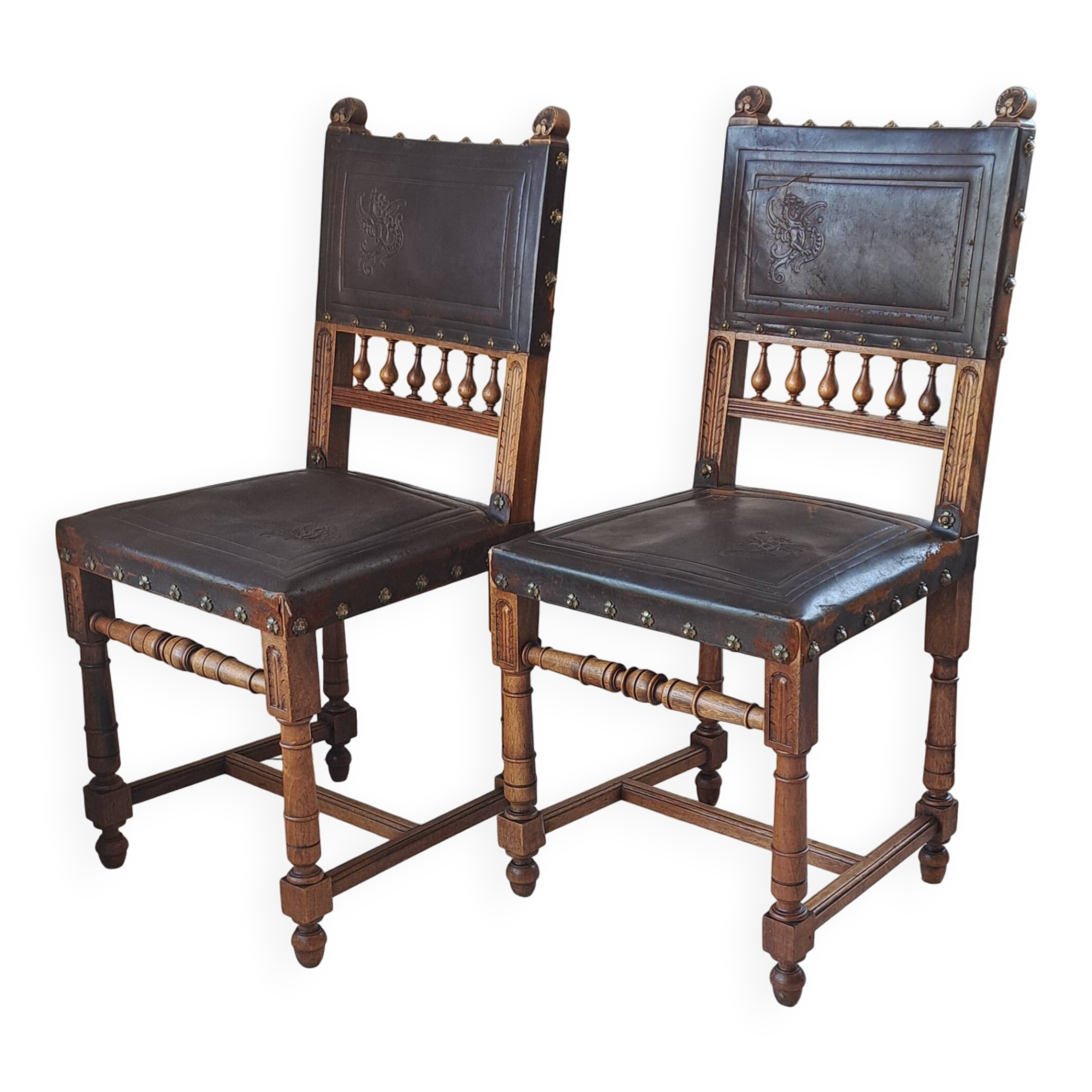 Pair of antique chairs in embossed leather, Henri II style.