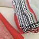 Tablecloth and 12 coral and grey napkins in a retro Scandinavian 1960s style.