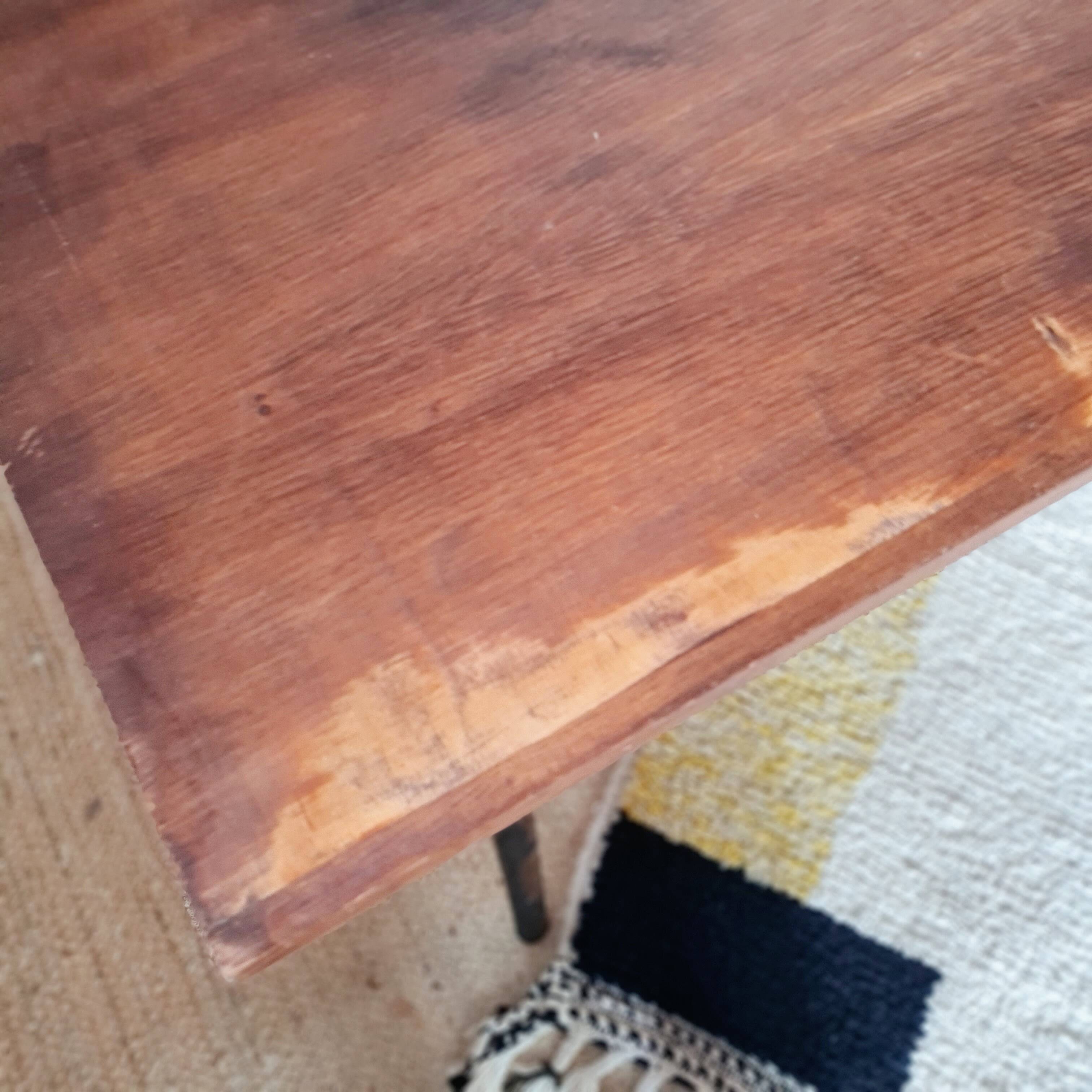 Table with tubular metal legs and wooden top.