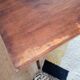 Table with tubular metal legs and wooden top.