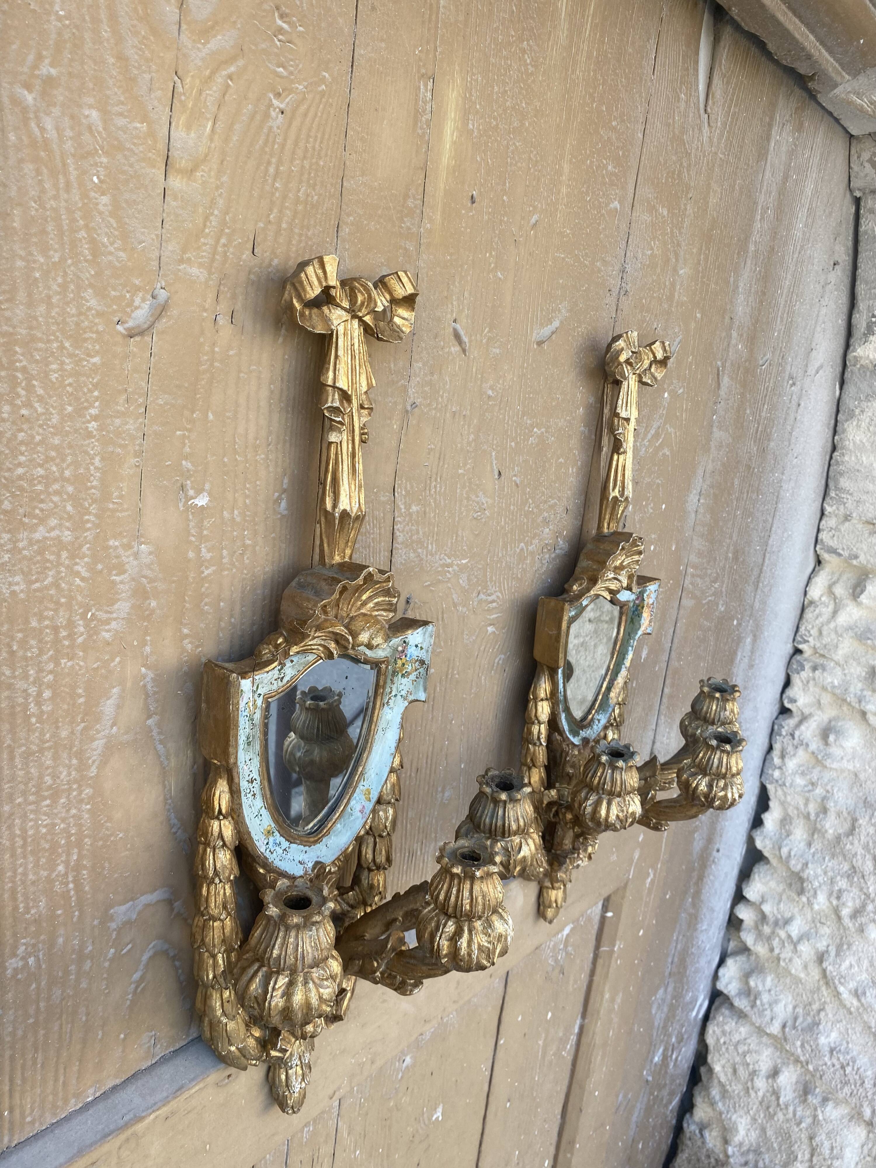 Pair of carved wood sconces