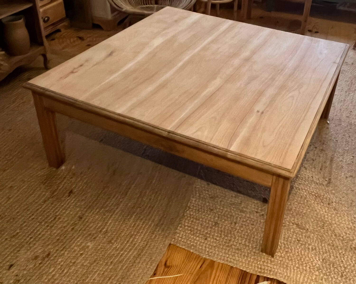 Large square antique coffee table made of raw solid wood.