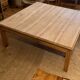 Large square antique coffee table made of raw solid wood.