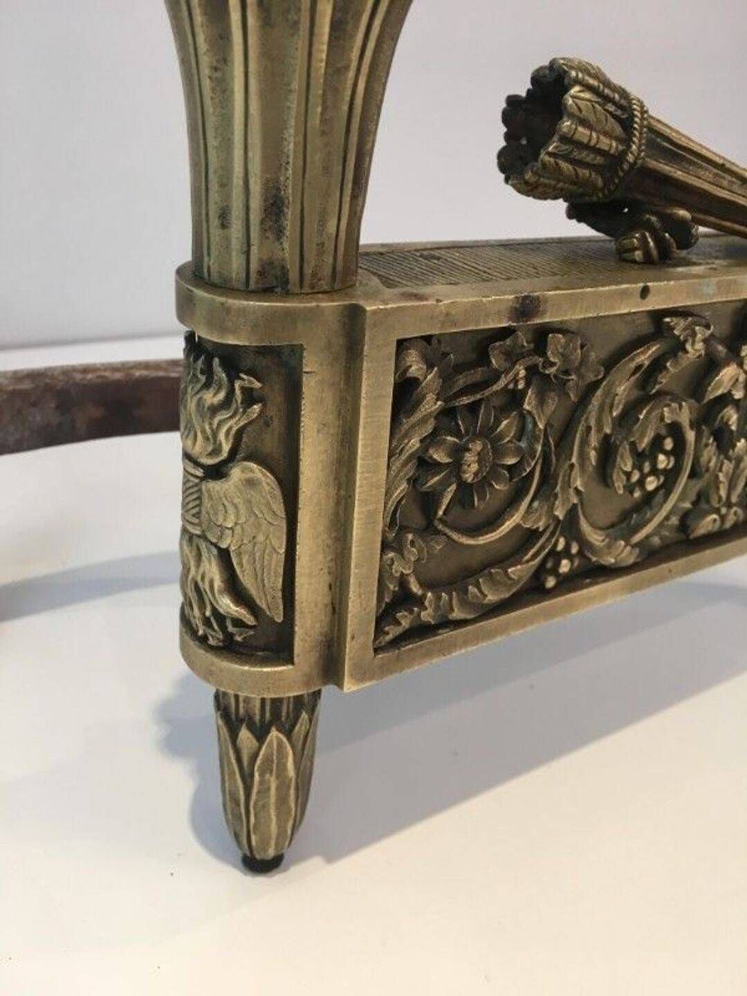 Pair of Empire Period Chenets in Chiselled Bronze with Torches and Leaf Frieze