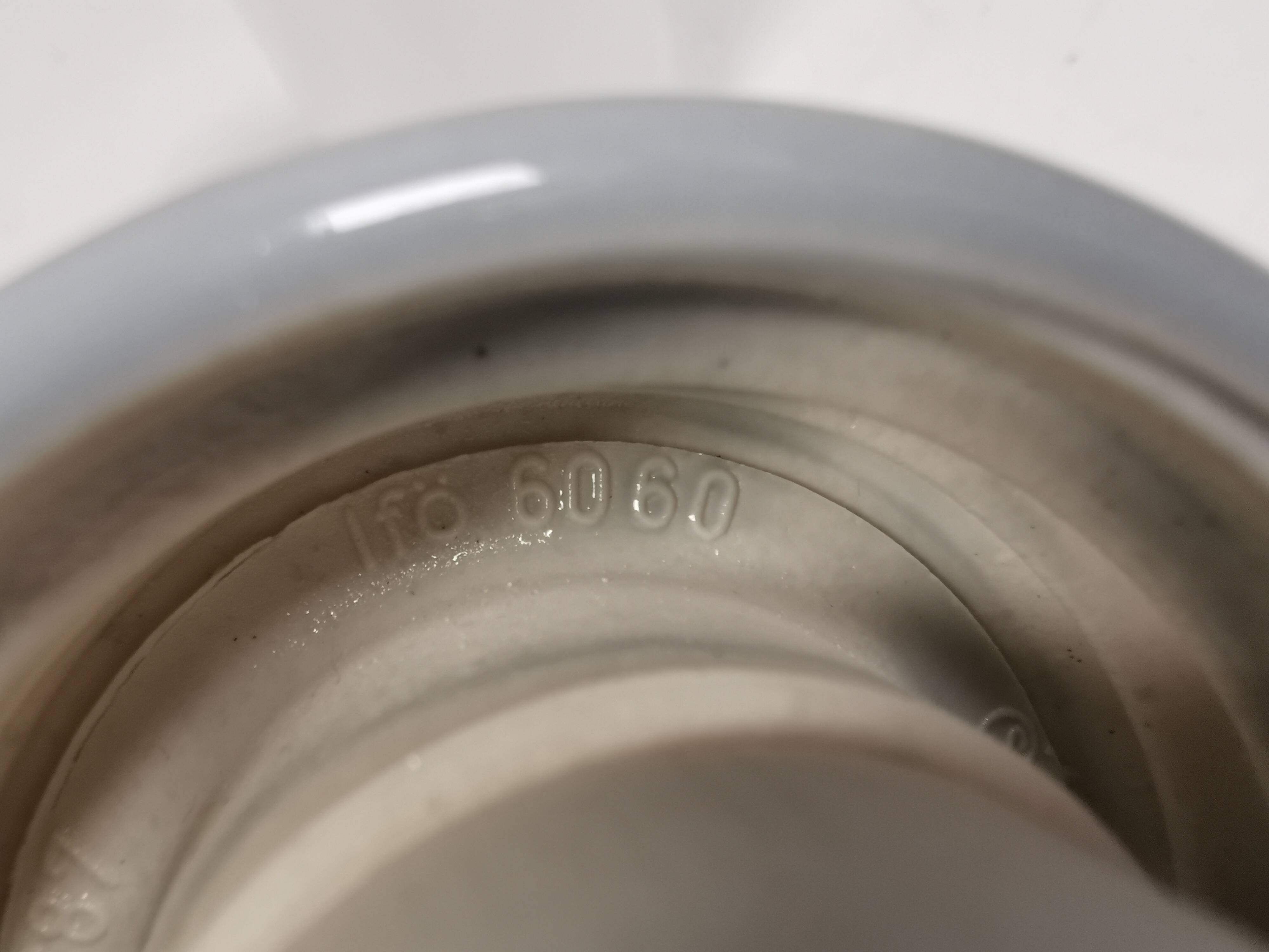 Bathroom lamp with light gray ceramic base,  and milky white opal glass.