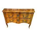 Large bow-fronted chest of drawers in blonde cherry with bronze ornamentation.