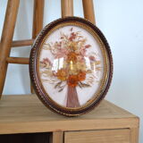Medallion of dried flowers with a domed frame