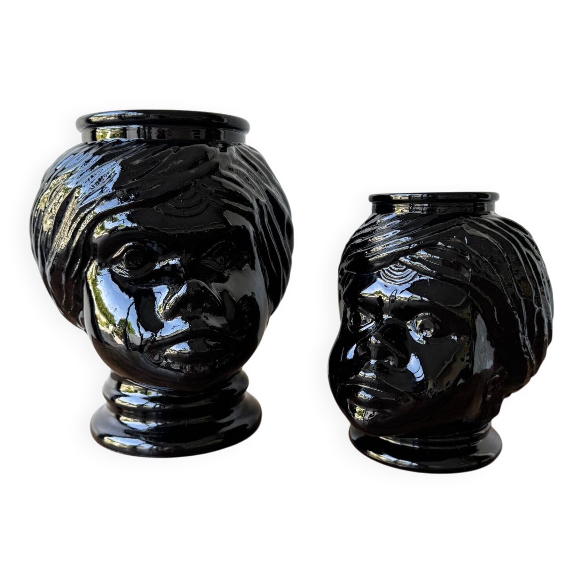 2 glass heads representing Moors