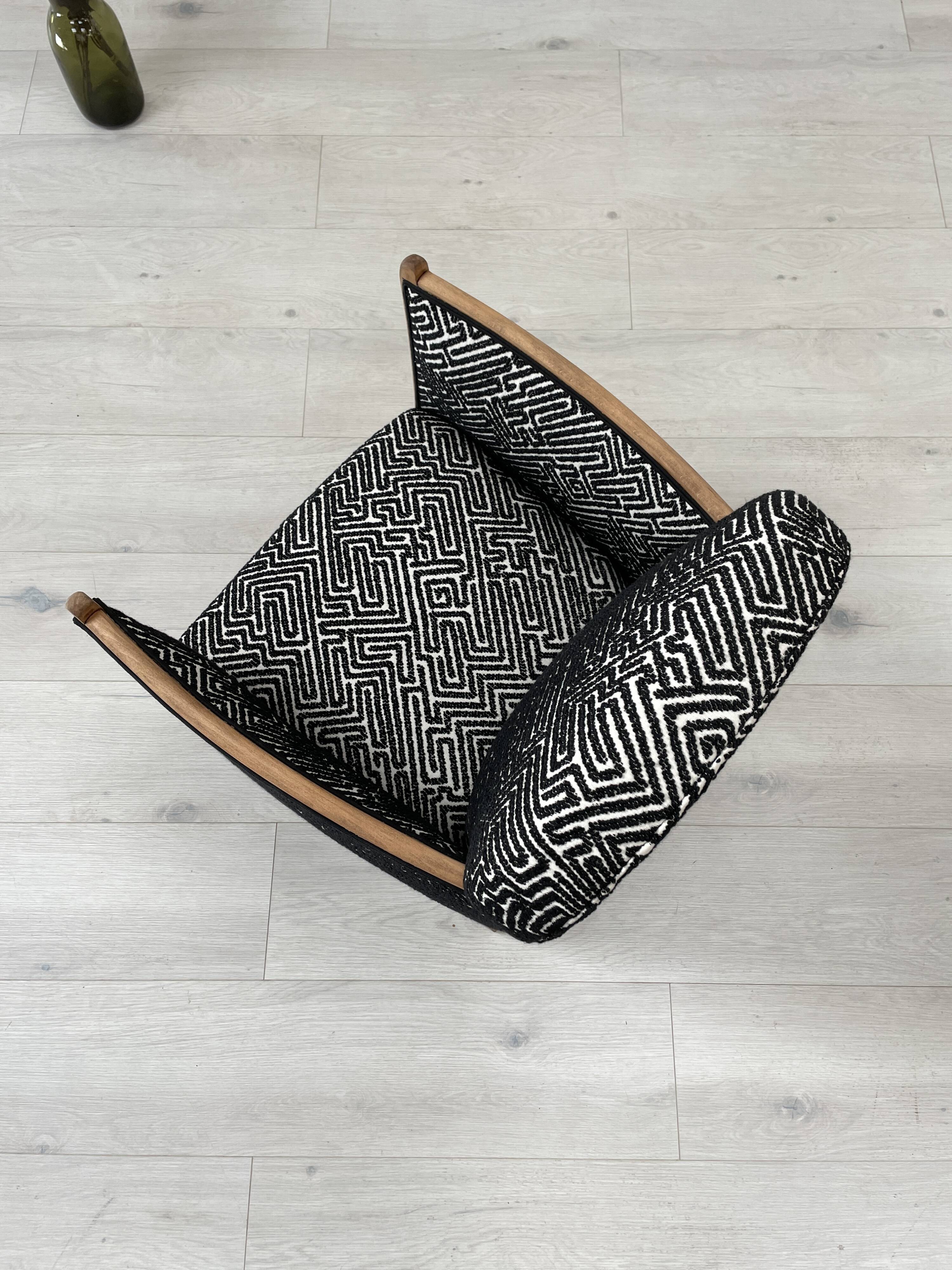 Club armchair in wood and fabric.