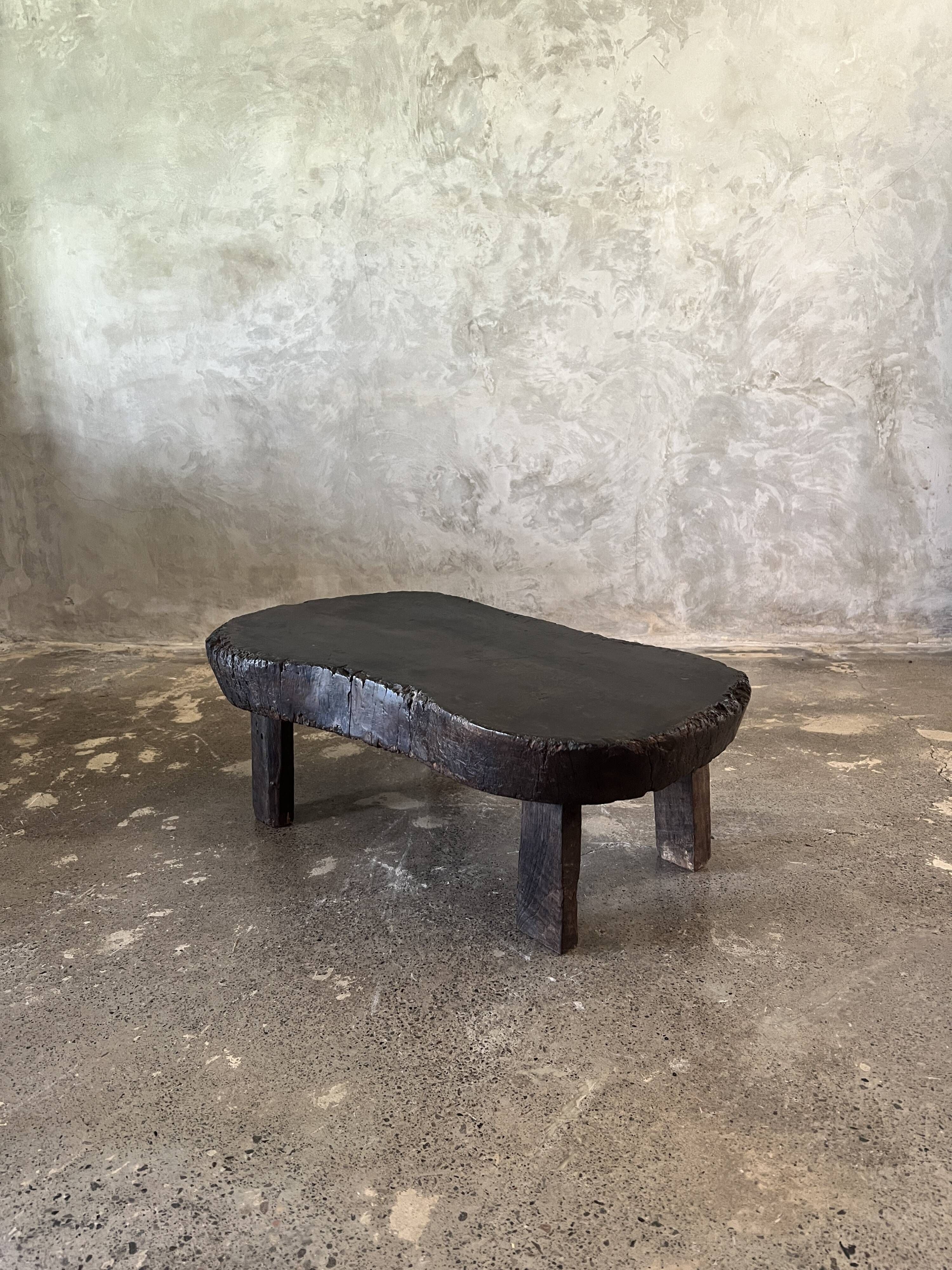 Small old Asian wooden coffee table in Japanese style, kidney-shaped top