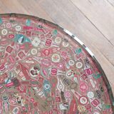 Small side table decorated with cigar rings under beveled glass