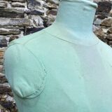 Old mannequin on wooden and fabric stand