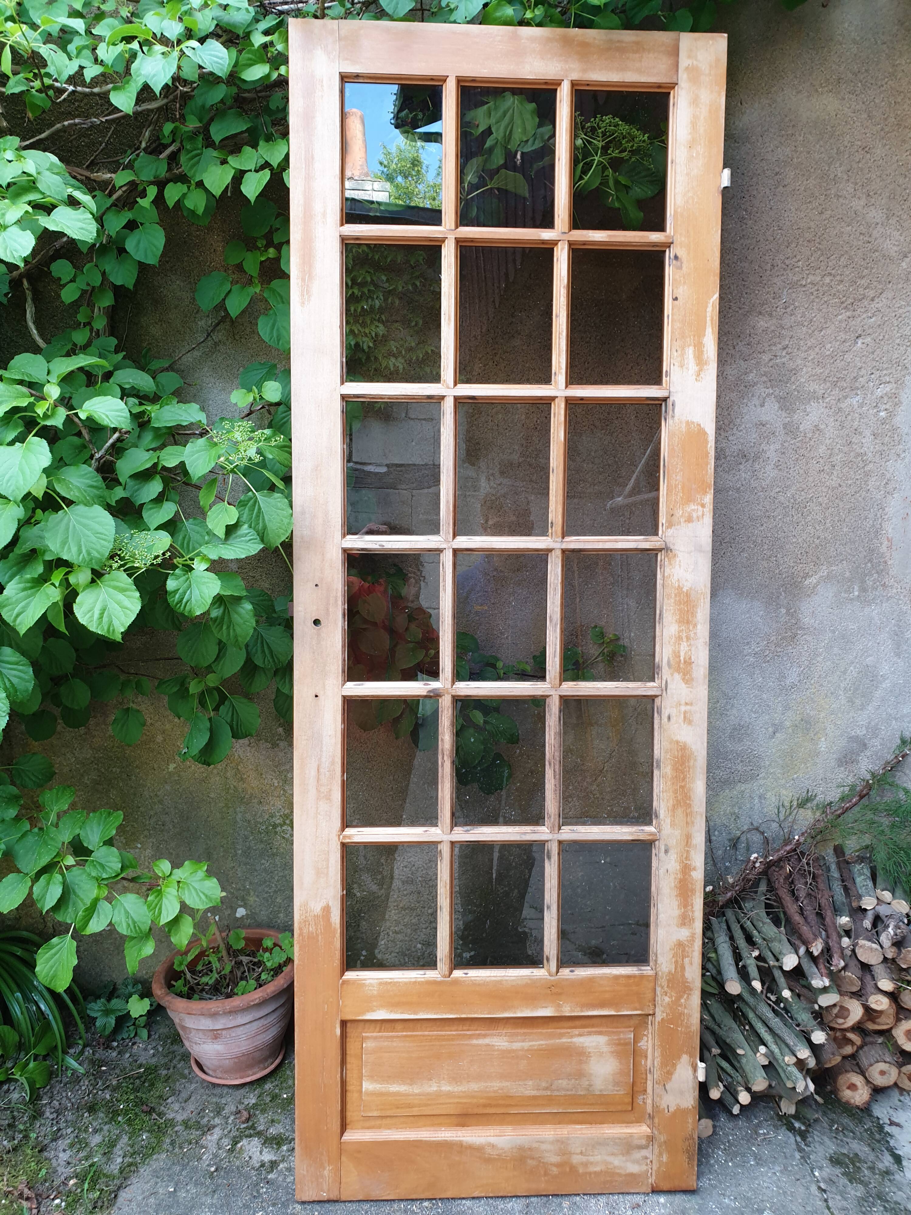 Old wooden door glazed with small tiles