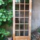 Old wooden door glazed with small tiles