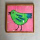 Wooden frame puzzle from the 1960s depicting a bird on a pink background.