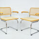 A pair of chairs with armrests, 1970s