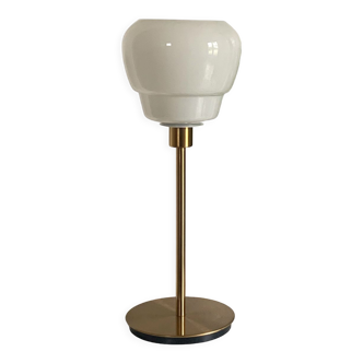 Table lamp with a white antique and vintage glass shade and a golden foot