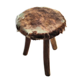 Rustic tripod stool seat covered with goatskin