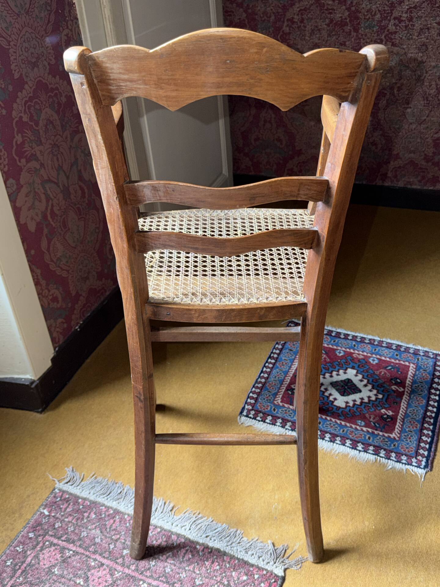Old wooden children's chair – caned seat – rustic furniture