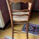 Old wooden children's chair – caned seat – rustic furniture