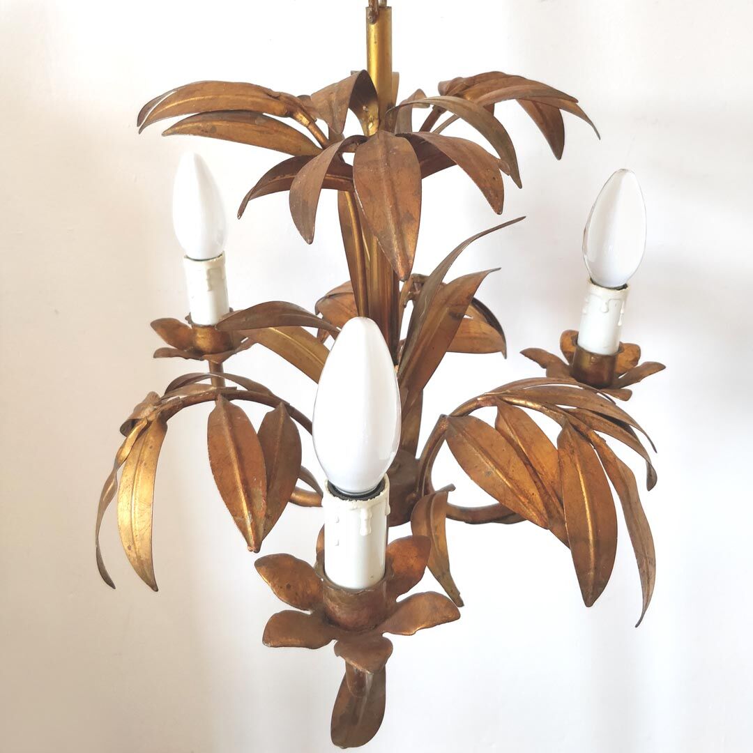 Golden metal chandelier palm leaves