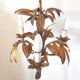 Golden metal chandelier palm leaves