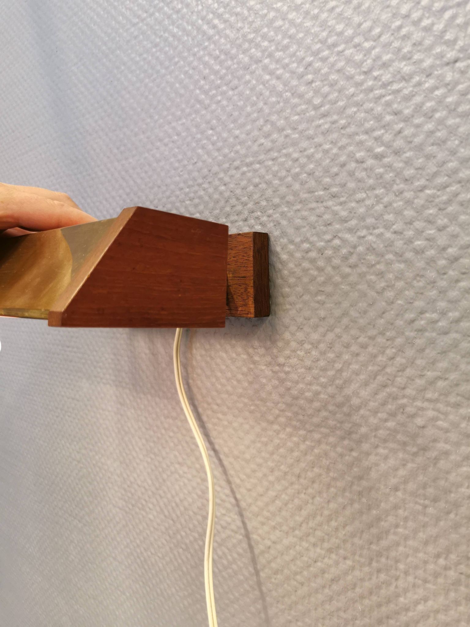 Fuga wall lamp in solid brass and teak wood was designed by Jo Hammerborg for Fog & Mørup in 1966.
