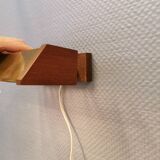 Fuga wall lamp in solid brass and teak wood was designed by Jo Hammerborg for Fog & Mørup in 1966.