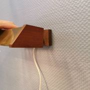 Fuga wall lamp in solid brass and teak wood was designed by Jo Hammerborg for Fog & Mørup in 1966.