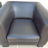 2 club armchairs with a chocolate faux leather seat and backrest and wooden legs.