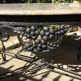Wrought iron table with openwork flower belt. marble top