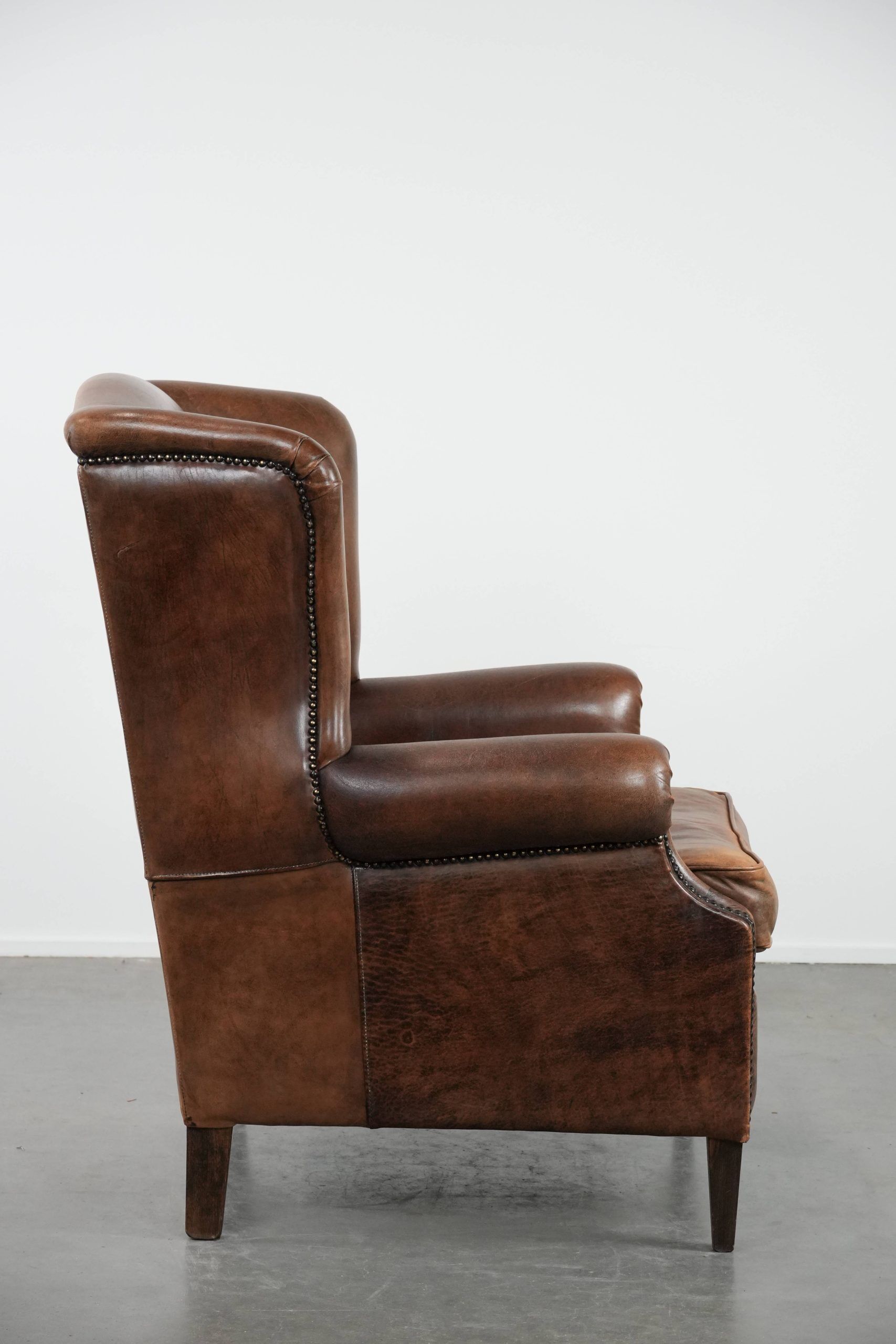 Warm, cosy and comfortable vintage sheepskin ear armchair with character