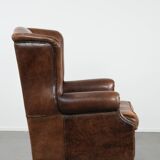 Warm, cosy and comfortable vintage sheepskin ear armchair with character
