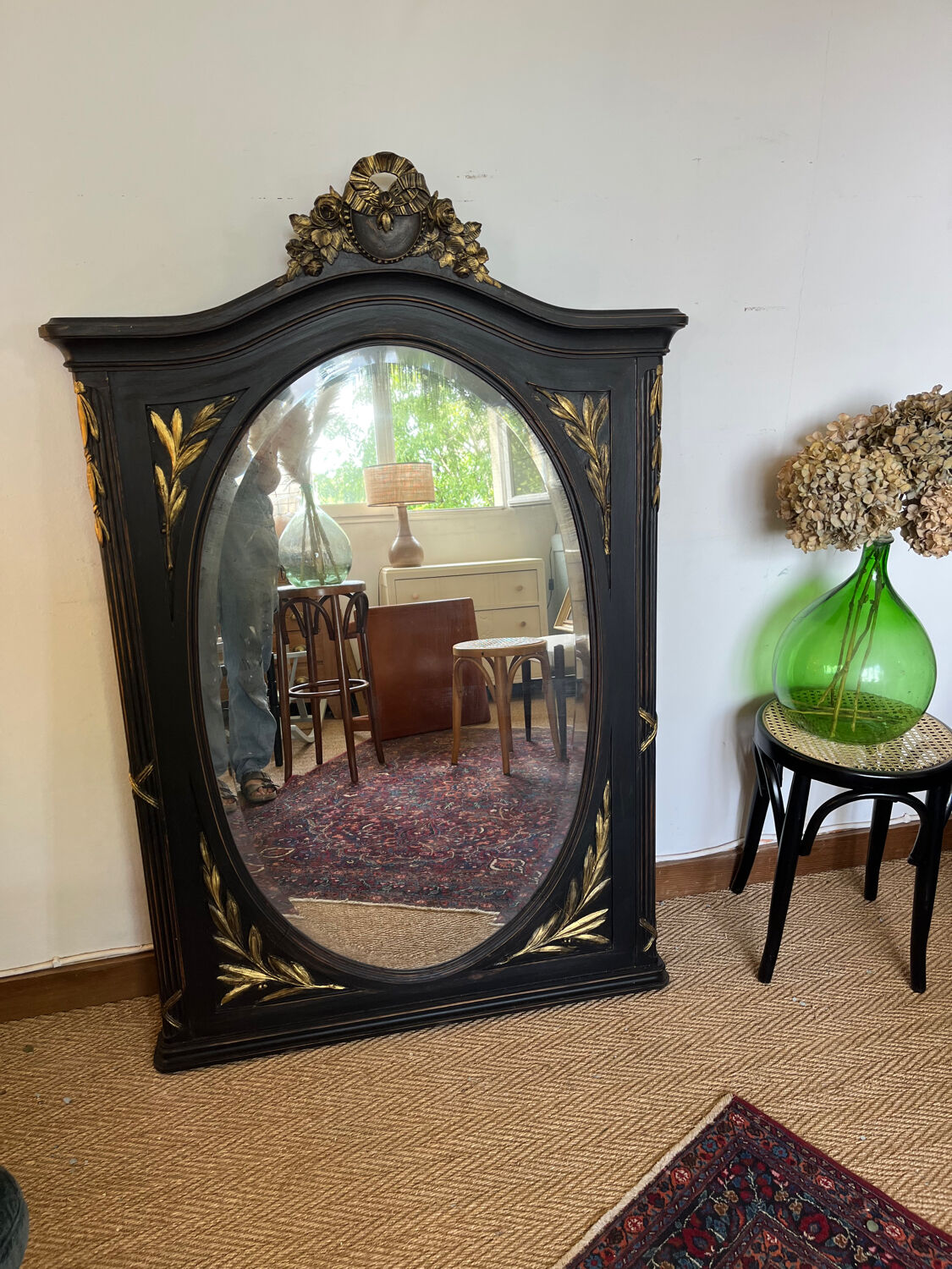Large old trumeau mirror in black and gilded wood Napoleon style