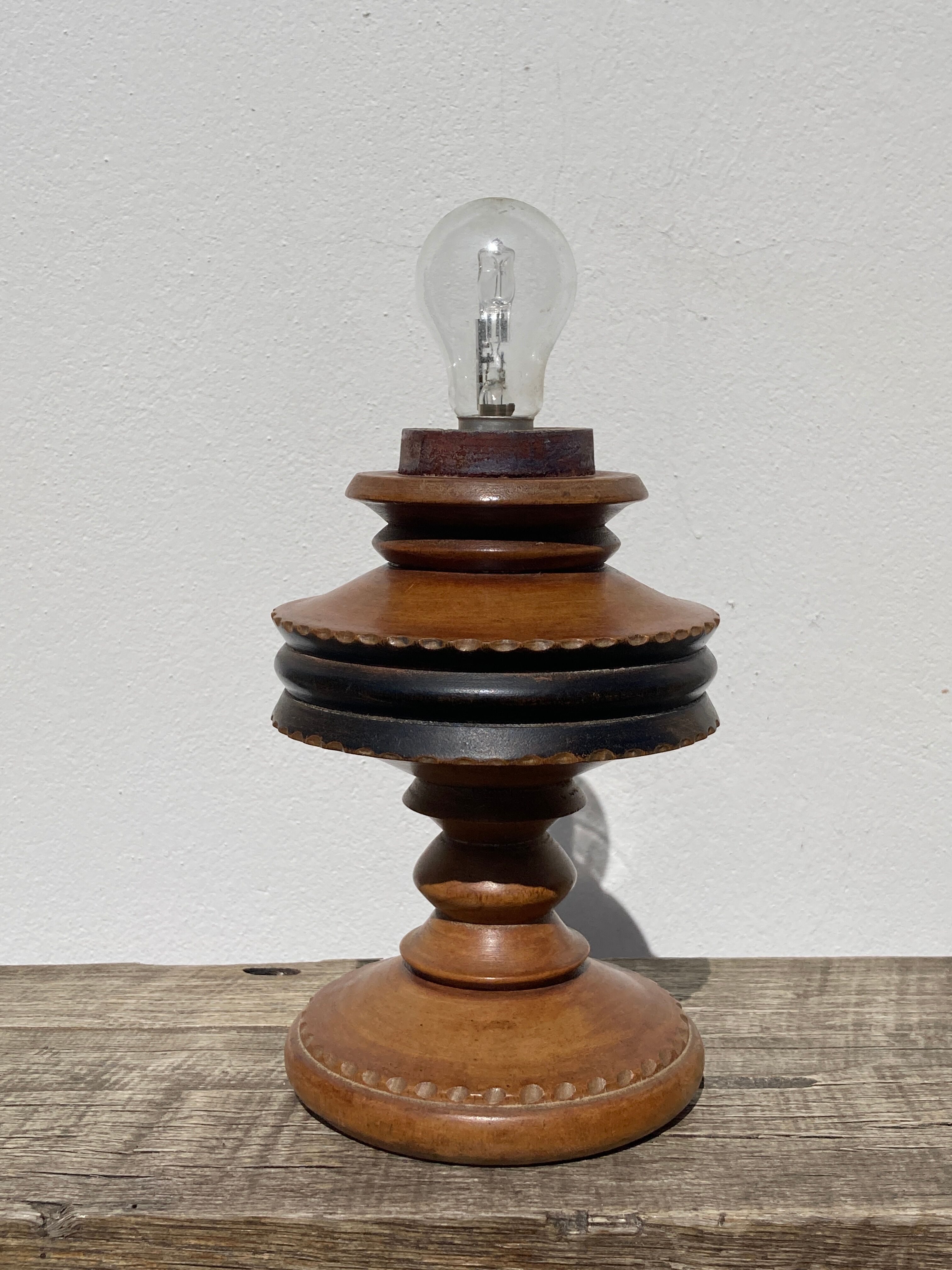 Foot of turned wooden lamp and carved