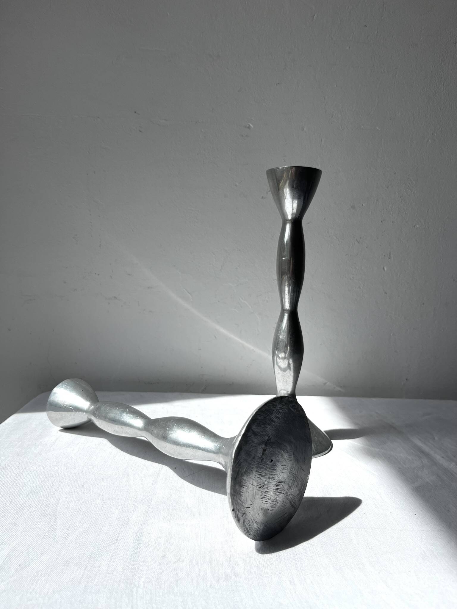 Pair of wavy aluminium candle holders
