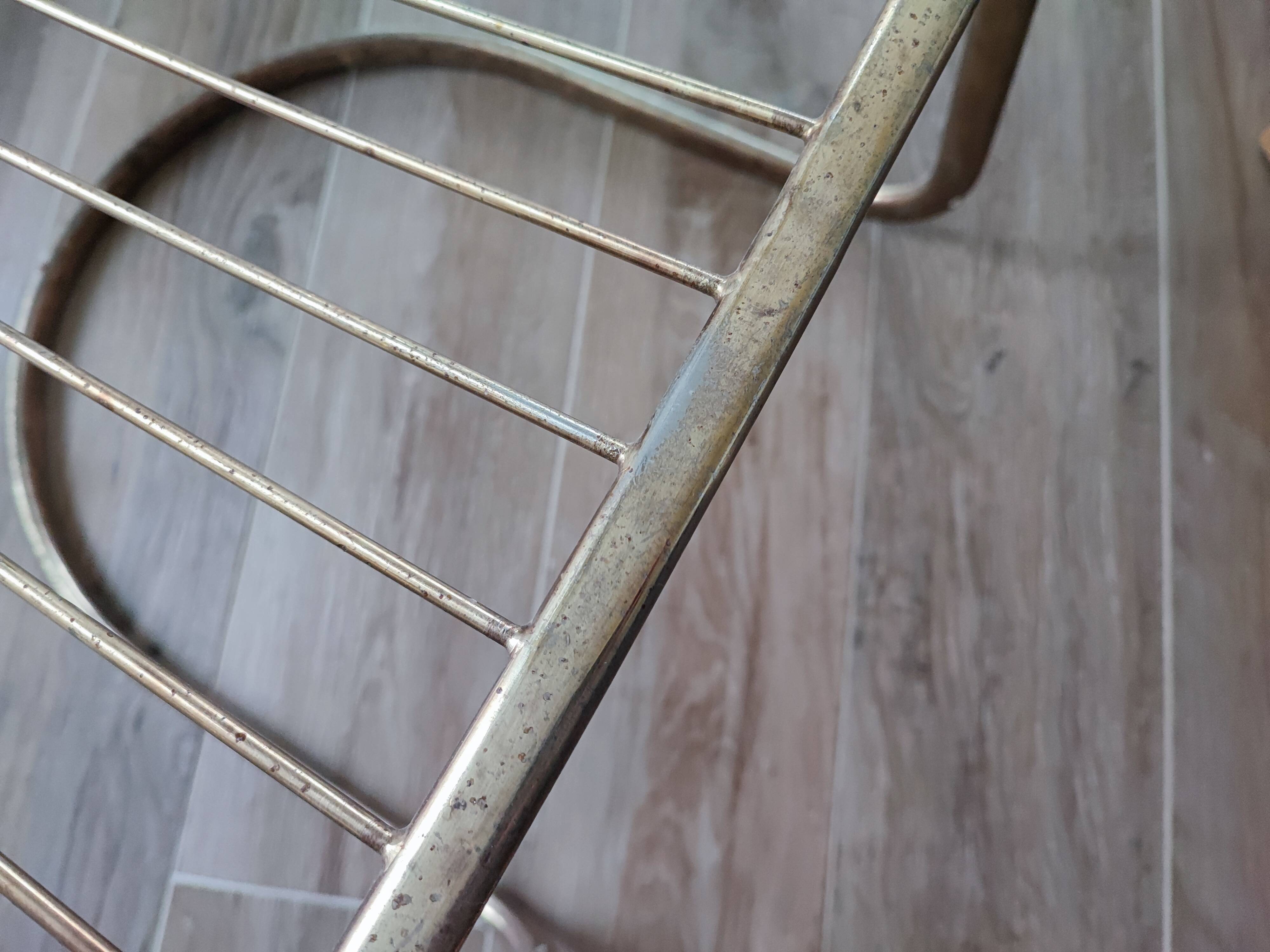 Tubular metal chair covered with gilding