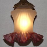 French Art Nouveau wall sconce in bronze with a white and pink glass shade.