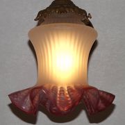 French Art Nouveau wall sconce in bronze with a white and pink glass shade.