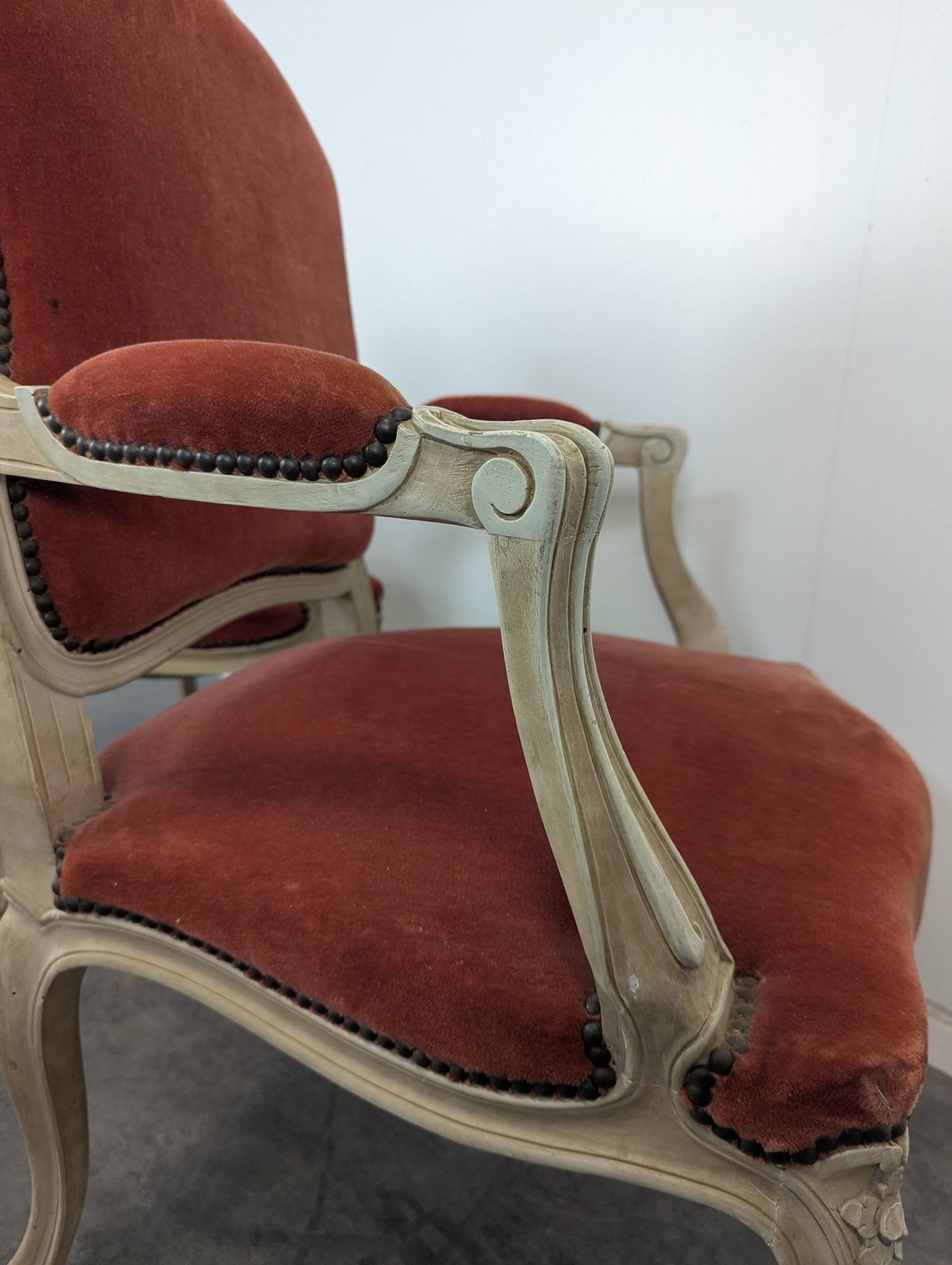 Pair of red cabriolet armchairs in Louis XV style
