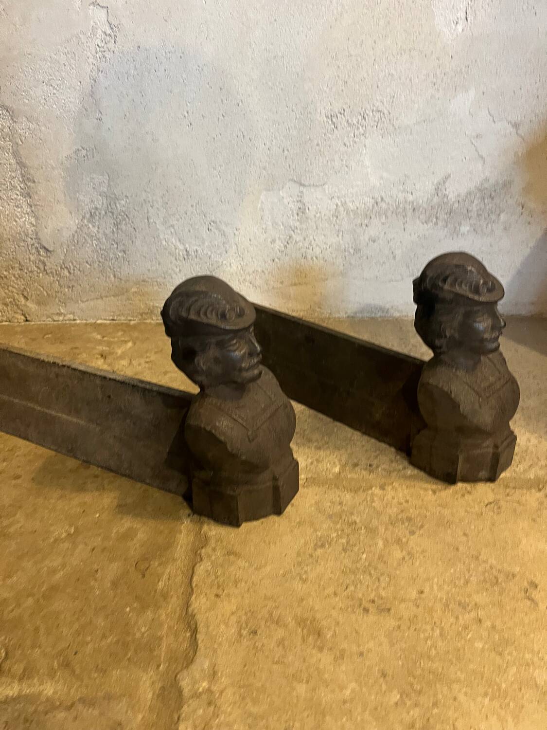 Pair of cast iron andirons with face