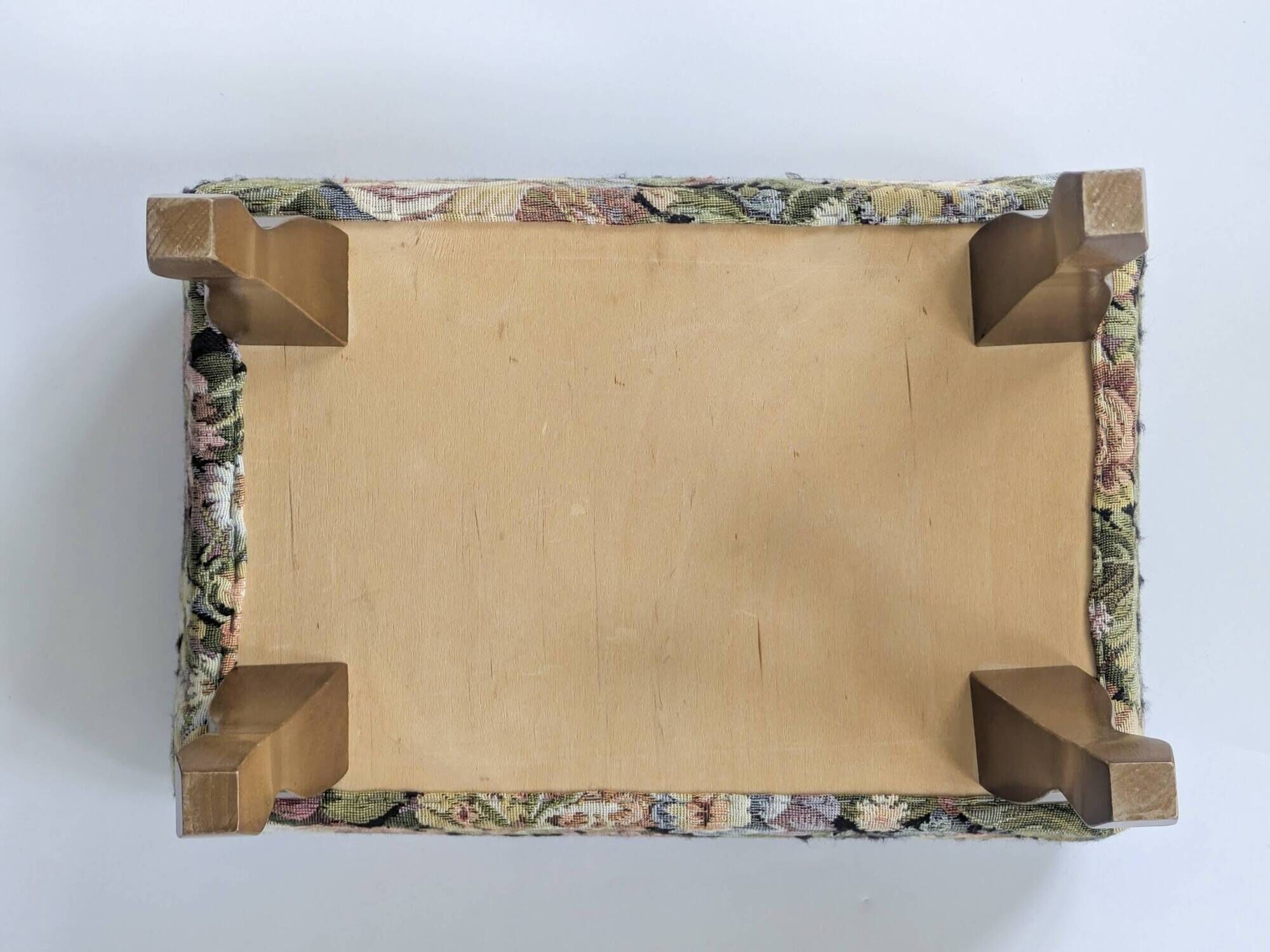 Large vintage upholstered footstool with curved legs.