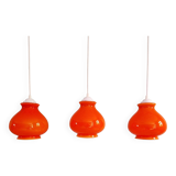 Trio of vintage orange opaline pendant lights, 1960-70