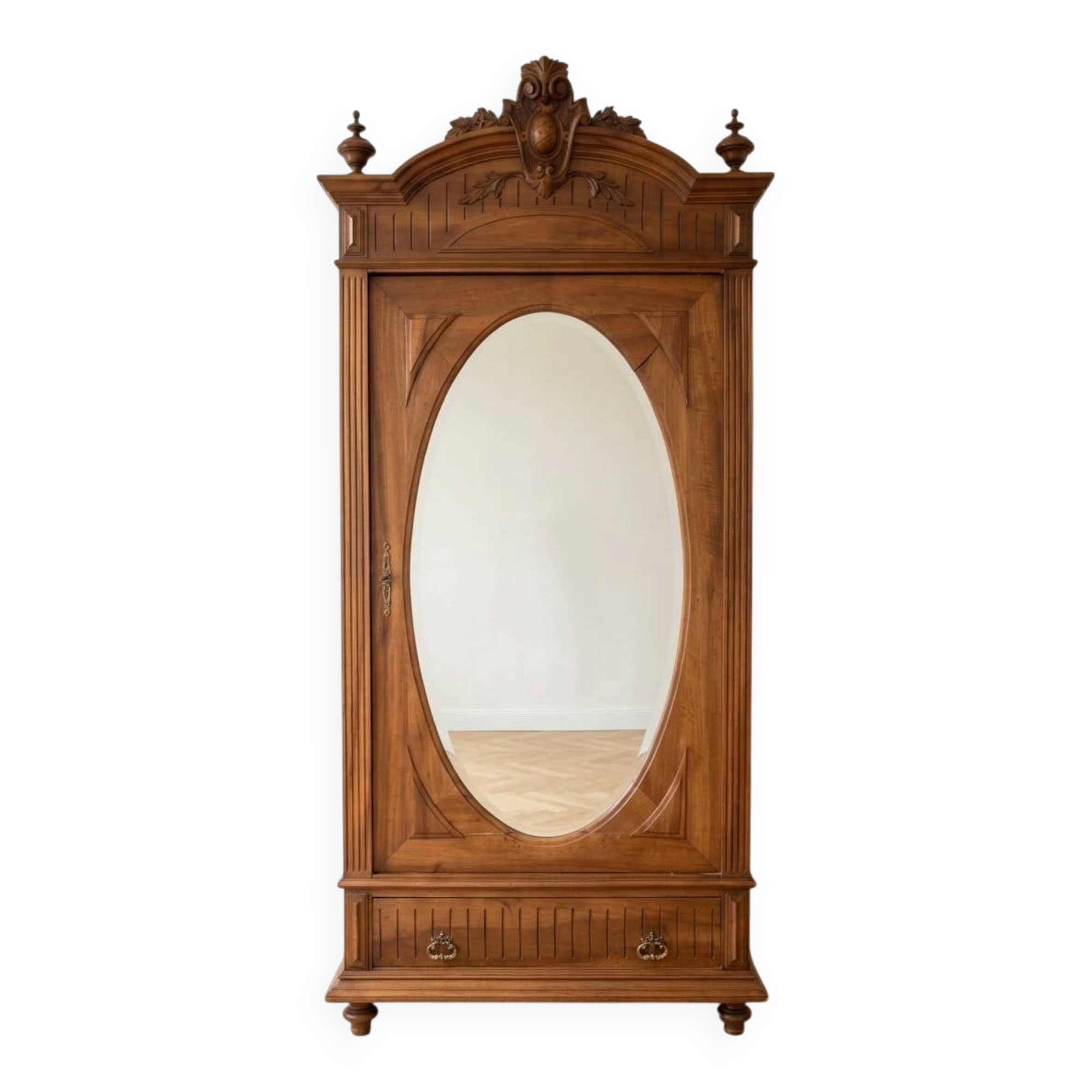 Antique solid wood wardrobe with an oval mirror.