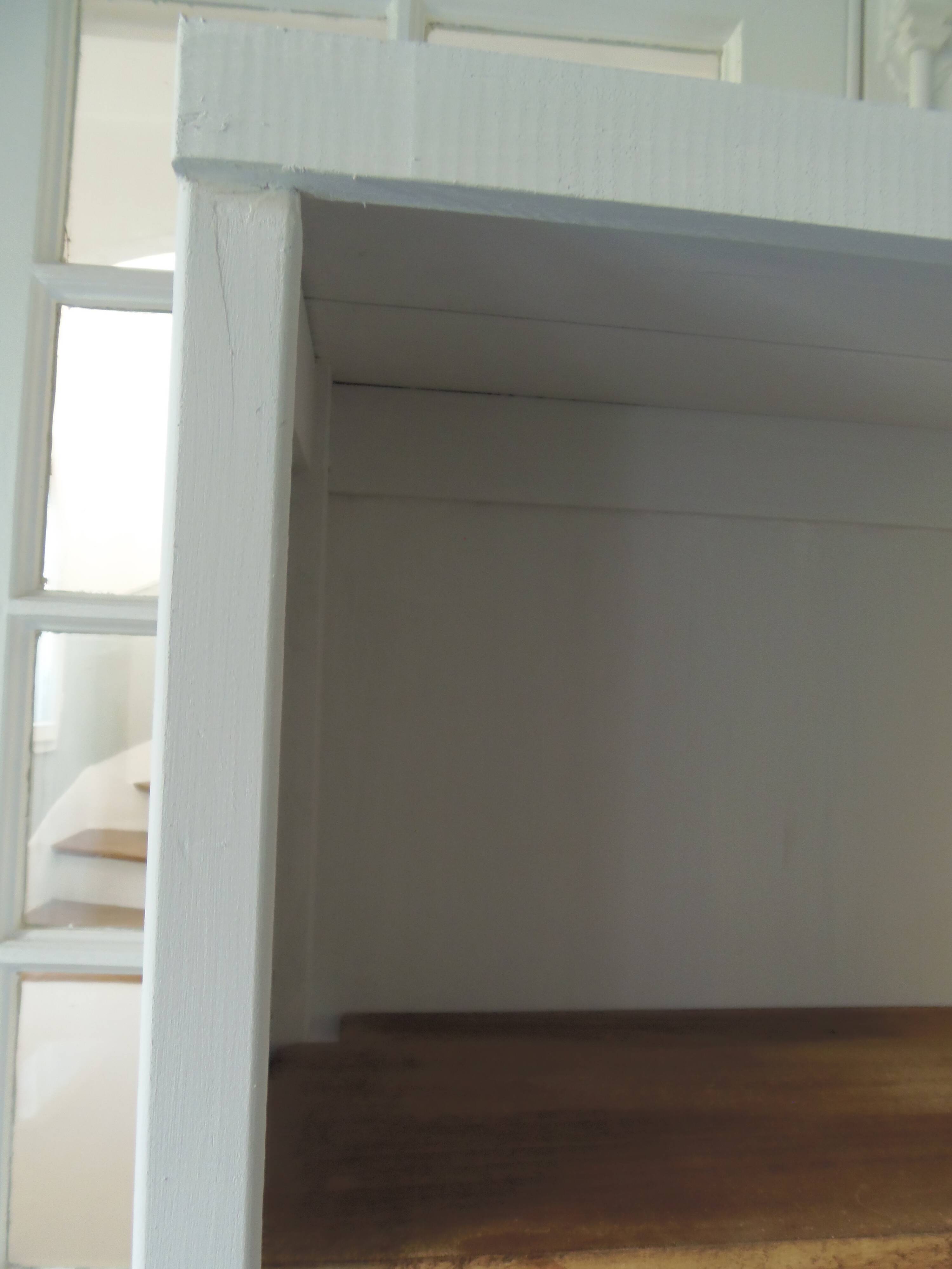 Shallow depth bookcase re-enchanted in pearl gray, wooden shelves.